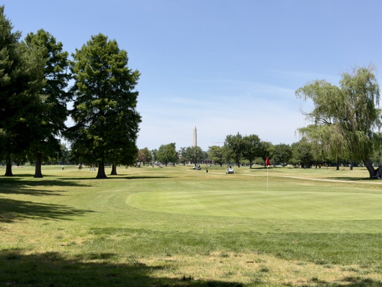 Third green at East Potomac Golf Links Red Course, red flag in the hole and the Washington Monument in the distance
