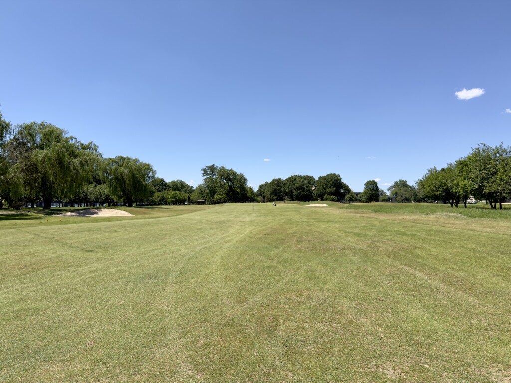 Second fairway at East Potomac White Course looking toward the green, bunkers left and right, willows down the left side